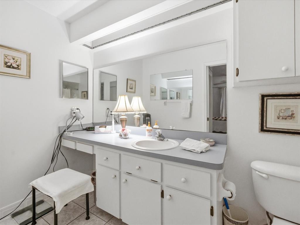 4209 Avanti Circle New Port Richey, FL 34655 - Photo 30 of 35 a bathroom with a granite countertop sink mirror and toilet