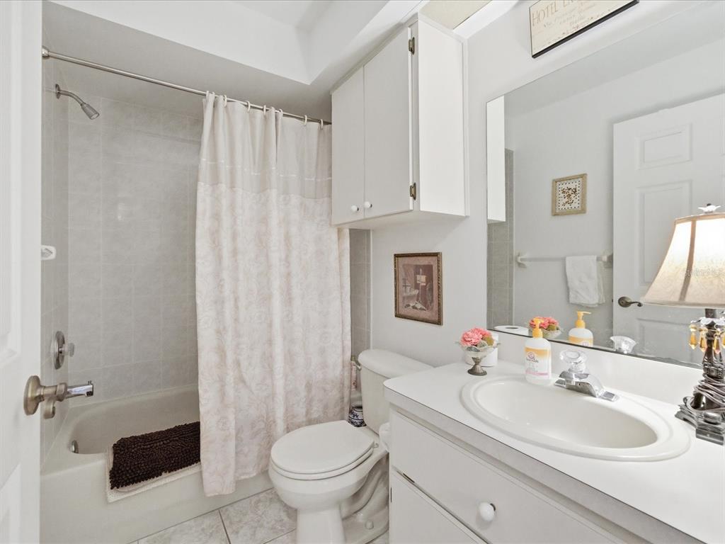 4209 Avanti Circle New Port Richey, FL 34655 - Photo 32 of 35 a bathroom with a sink toilet a mirror and shower