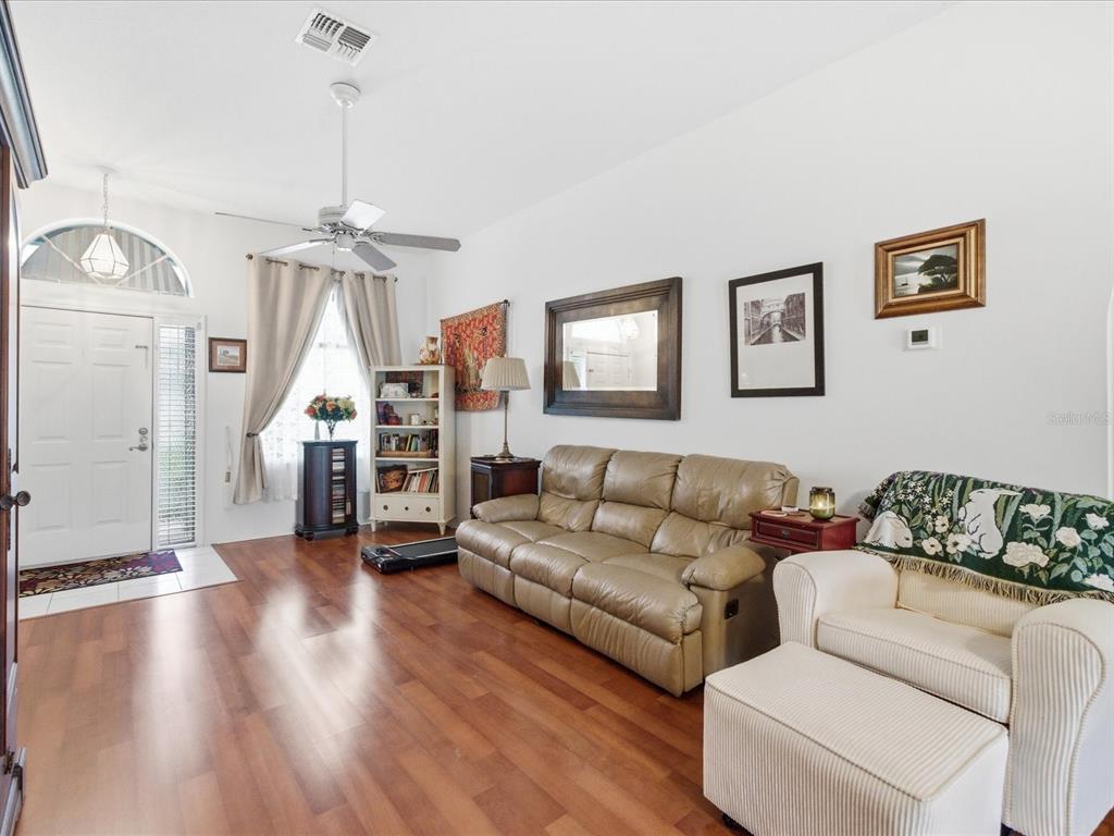 4209 Avanti Circle New Port Richey, FL 34655 - Photo 5 of 35 a living room with furniture and a wooden floor