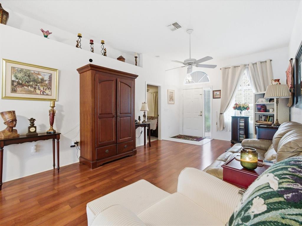 4209 Avanti Circle New Port Richey, FL 34655 - Photo 6 of 35 a living room with furniture a wooden floor and a ceiling fan