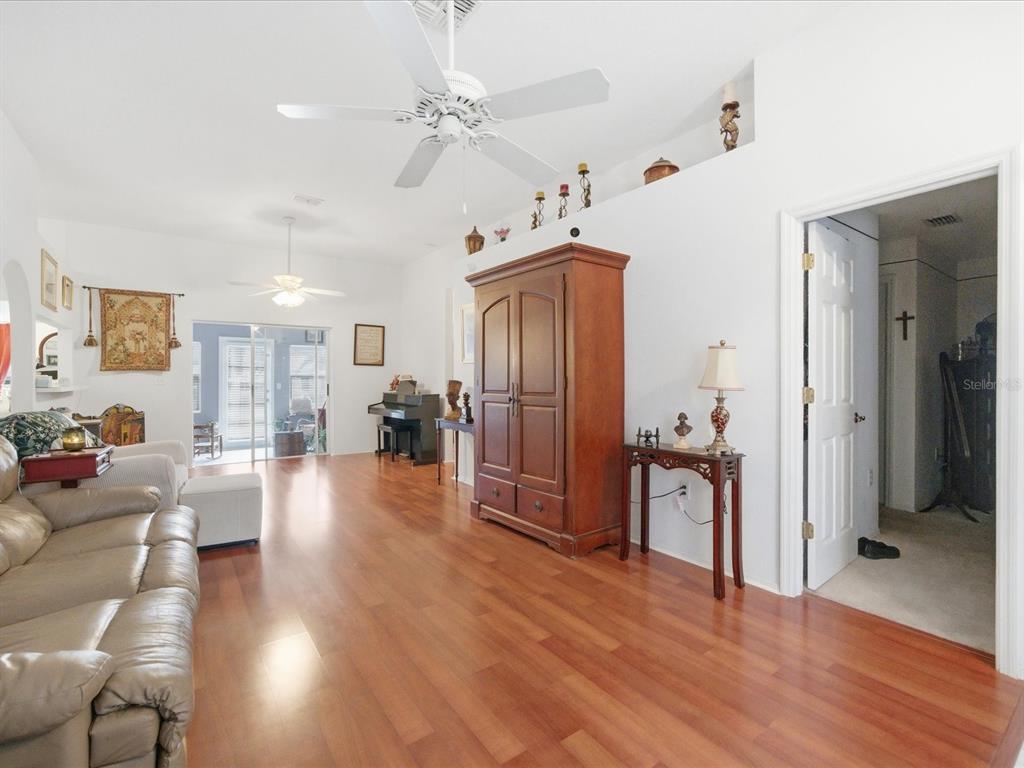 4209 Avanti Circle New Port Richey, FL 34655 - Photo 7 of 35 a view of a livingroom with furniture wooden floor and a ceiling fan