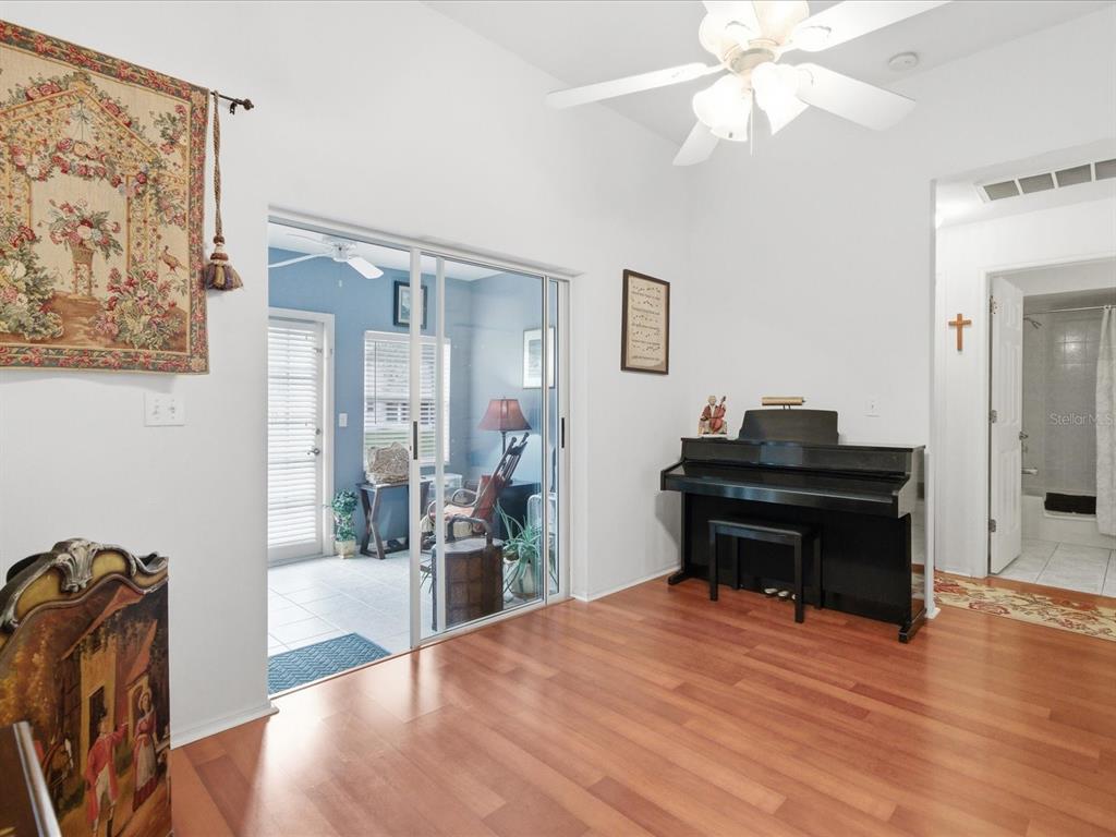 4209 Avanti Circle New Port Richey, FL 34655 - Photo 9 of 35 a room with a piano table and chair