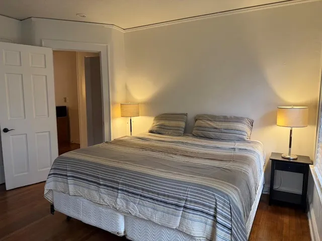 a bedroom with a bed and a lamp