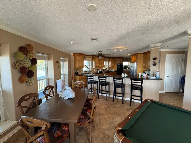 a dining room with furniture and wooden floor