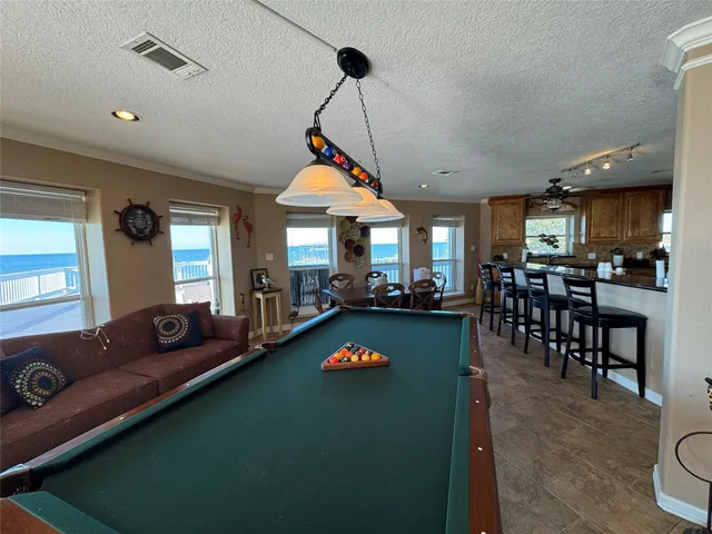 a living room with furniture a dining table and kitchen view