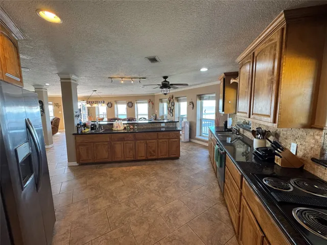 a spacious bedroom with a bed and a chandelier
