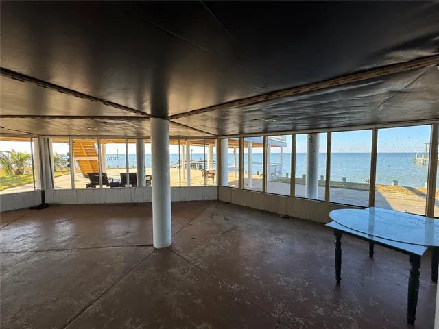 a view of a room with dining table and chairs