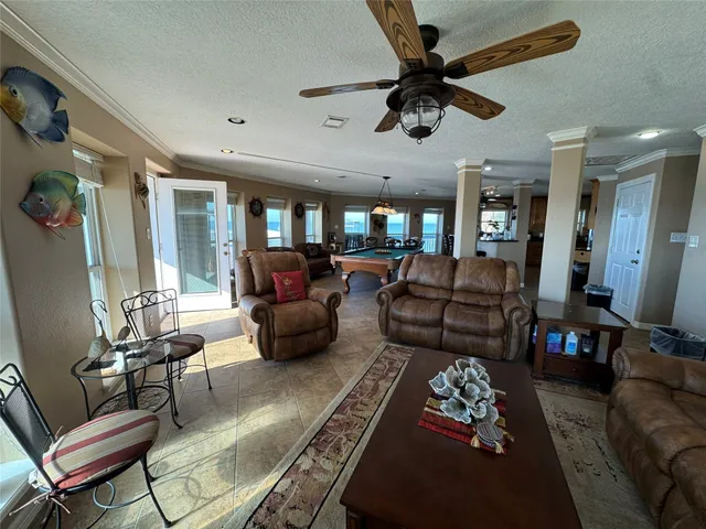 a living room with furniture ceiling fan and a rug