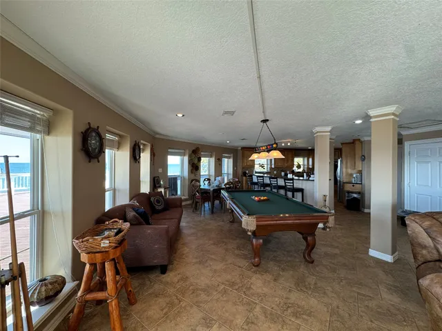 a room with furniture pool table table tennis window