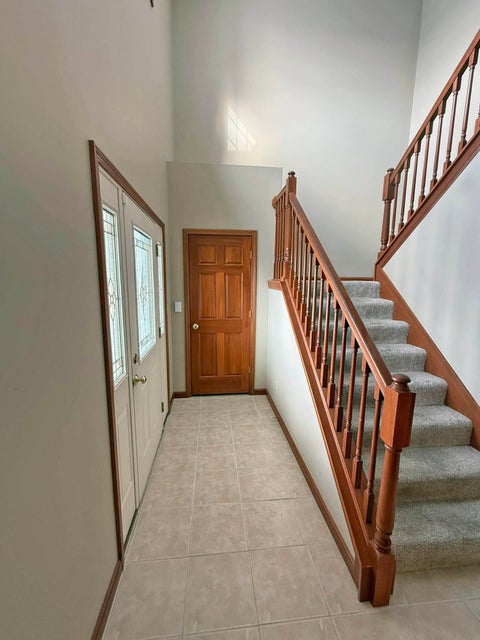 541 North Point Troy, OH 45373 - Photo 3 of 23 This inviting foyer features a grand staircase and durable tiled flooring.