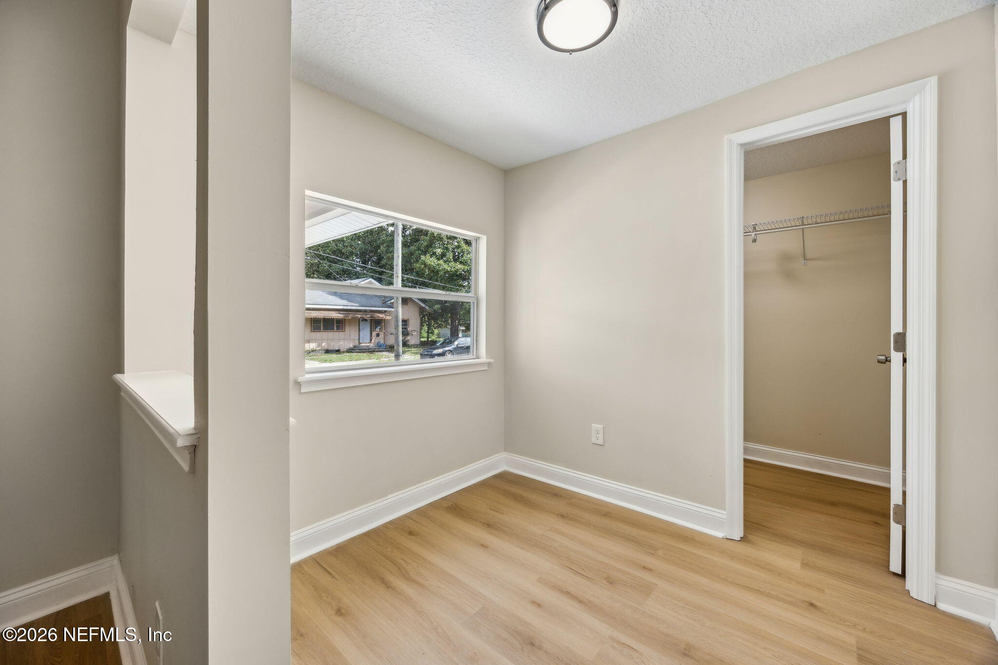 2562 Summit Street Jacksonville, FL 32204 - Photo 12 of 20 a view of an empty room with wooden floor and a window