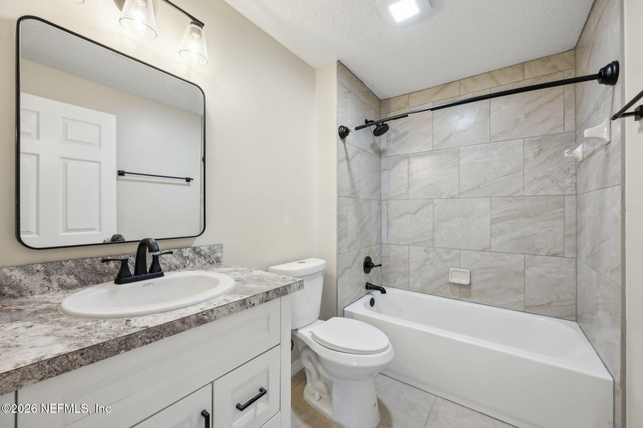 2562 Summit Street Jacksonville, FL 32204 - Photo 17 of 20 a bathroom with a granite countertop sink toilet mirror and shower