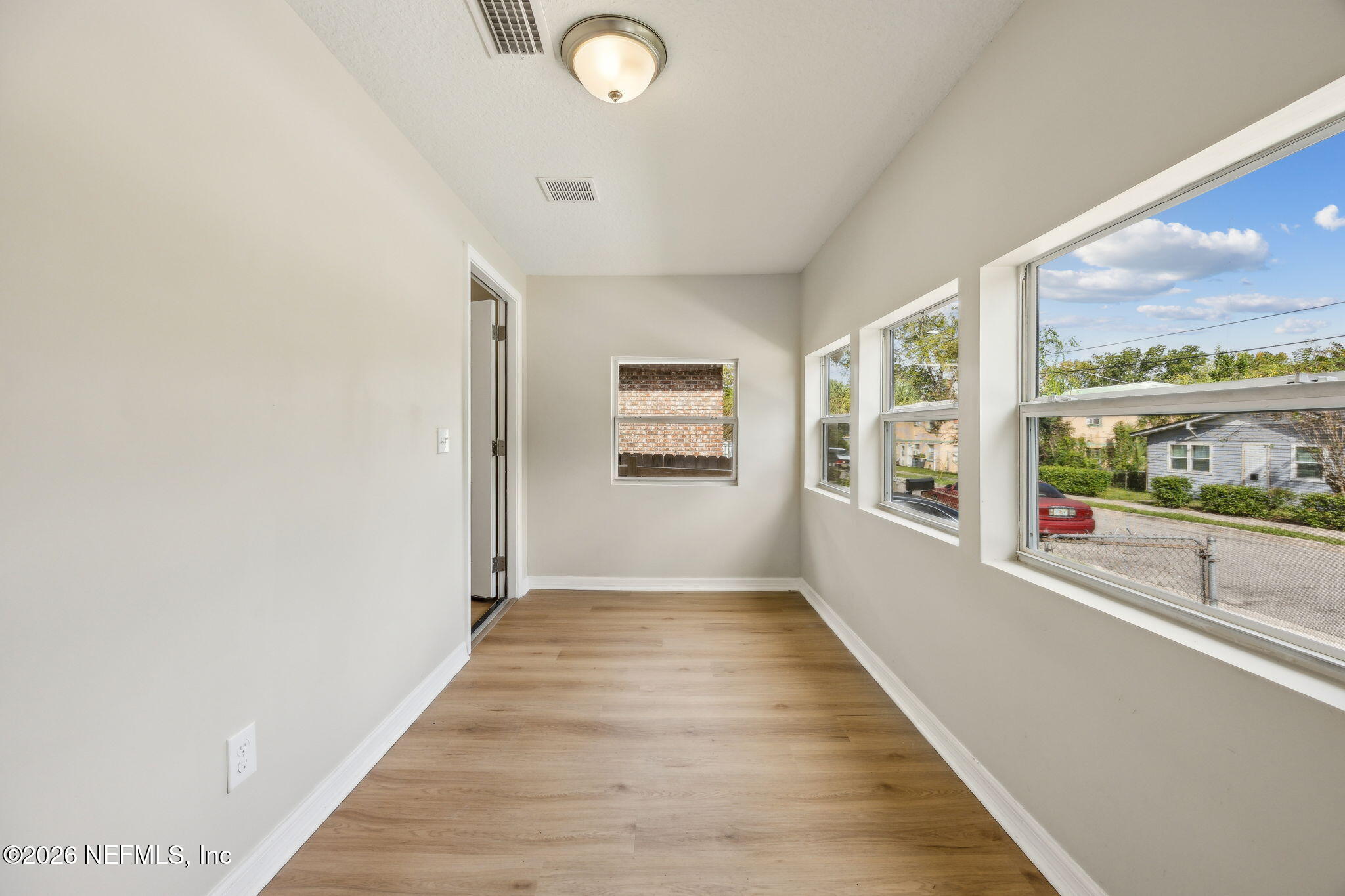 2562 Summit Street Jacksonville, FL 32204 - Photo 4 of 20 wooden floor in an empty room with a window