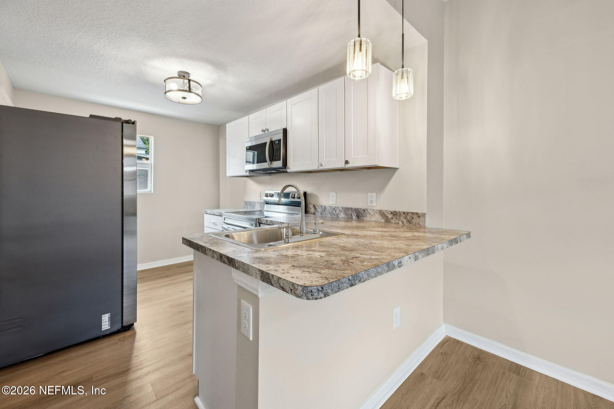 2562 Summit Street Jacksonville, FL 32204 - Photo 8 of 20 a kitchen with stainless steel appliances granite countertop a sink stove and cabinets