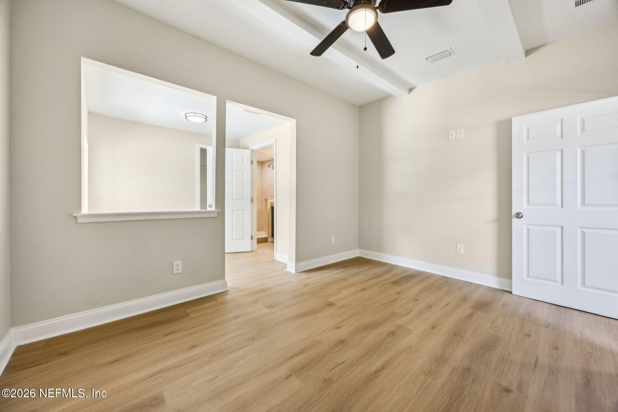 2562 Summit Street Jacksonville, FL 32204 - Photo 9 of 20 a view of an empty room with wooden floor and a window