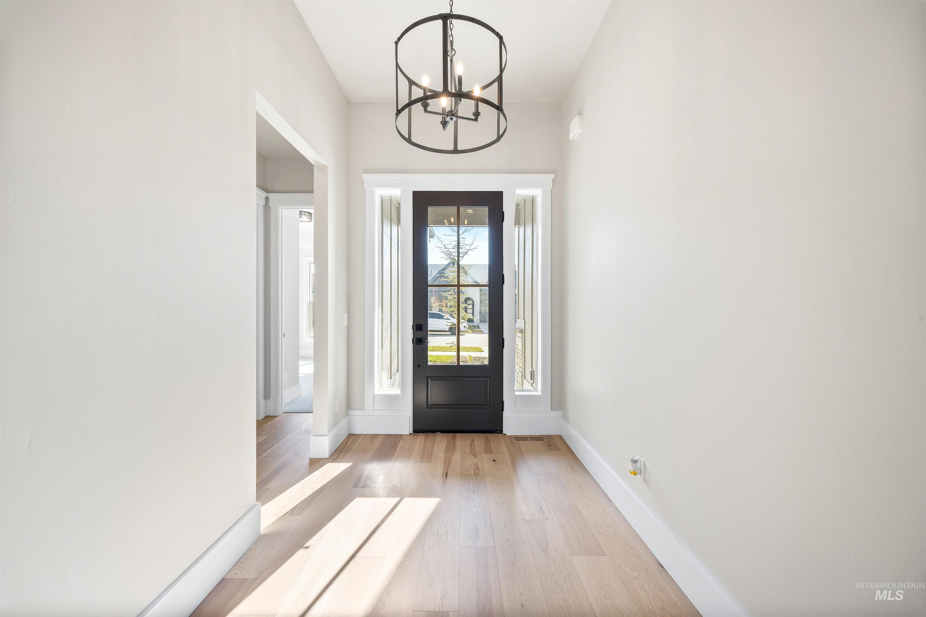 1126 East Crescendo Street Meridian, ID 83642 - Photo 4 of 48 Entryway with light wood-type flooring and a chandelier