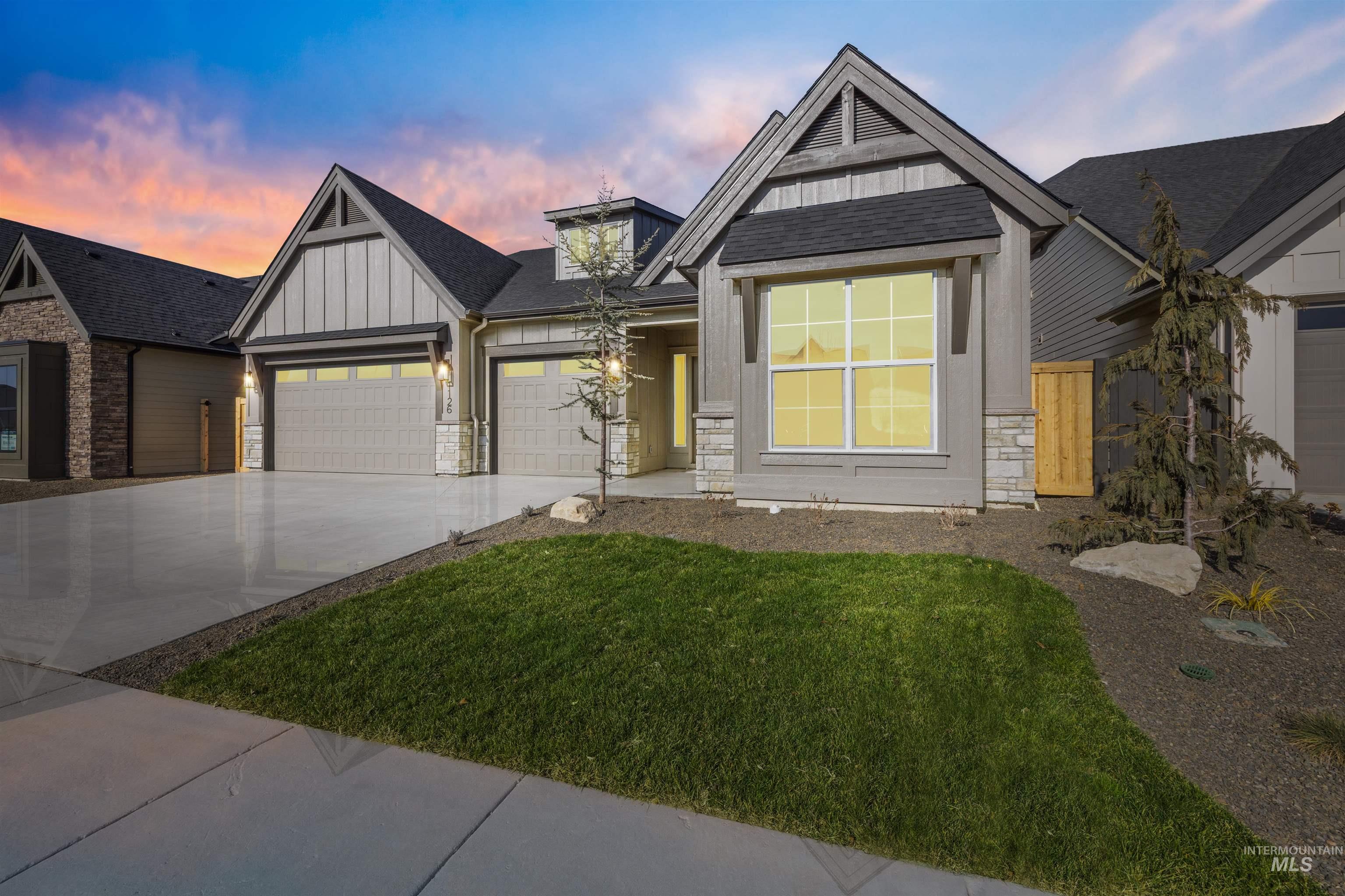 1126 East Crescendo Street Meridian, ID 83642 - Photo 46 of 48 View of front of house with board and batten siding, stone siding, a garage, concrete driveway, and a shingled roof