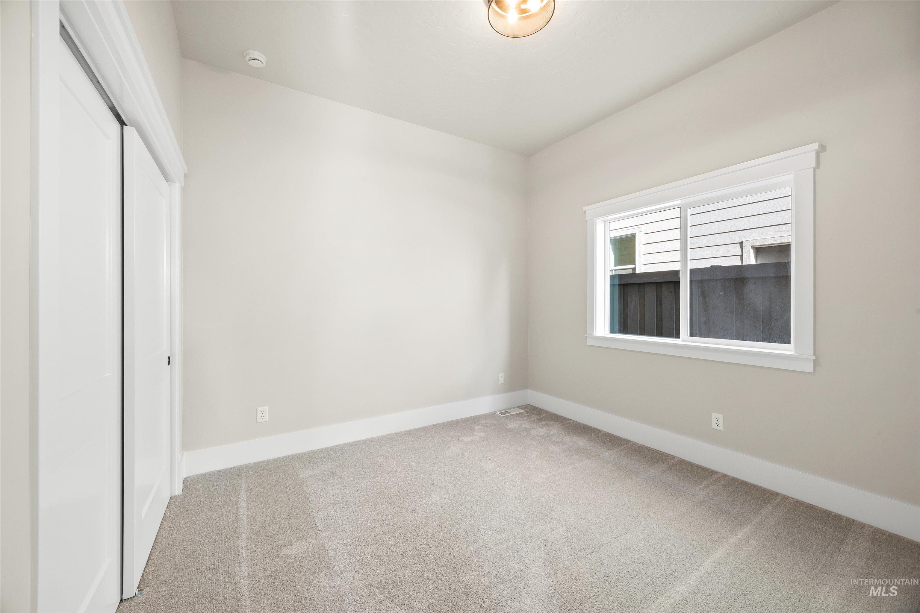 1126 East Crescendo Street Meridian, ID 83642 - Photo 8 of 48 Unfurnished bedroom with light colored carpet and a closet
