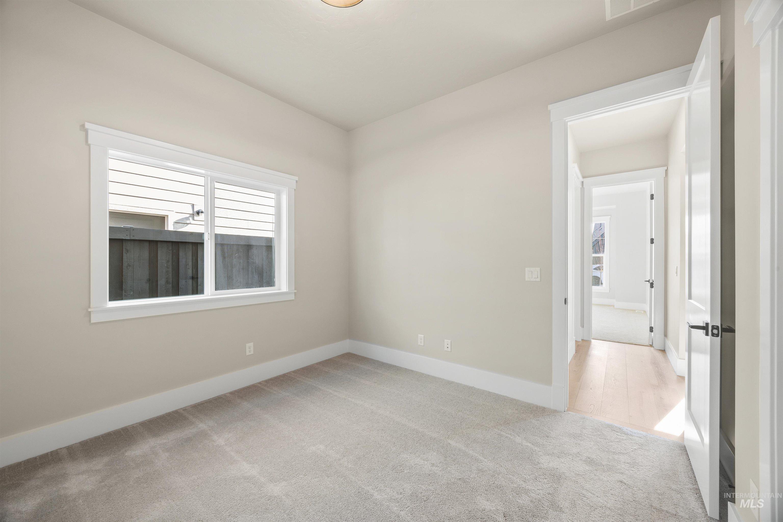 1126 East Crescendo Street Meridian, ID 83642 - Photo 9 of 48 Unfurnished room featuring light carpet and baseboards