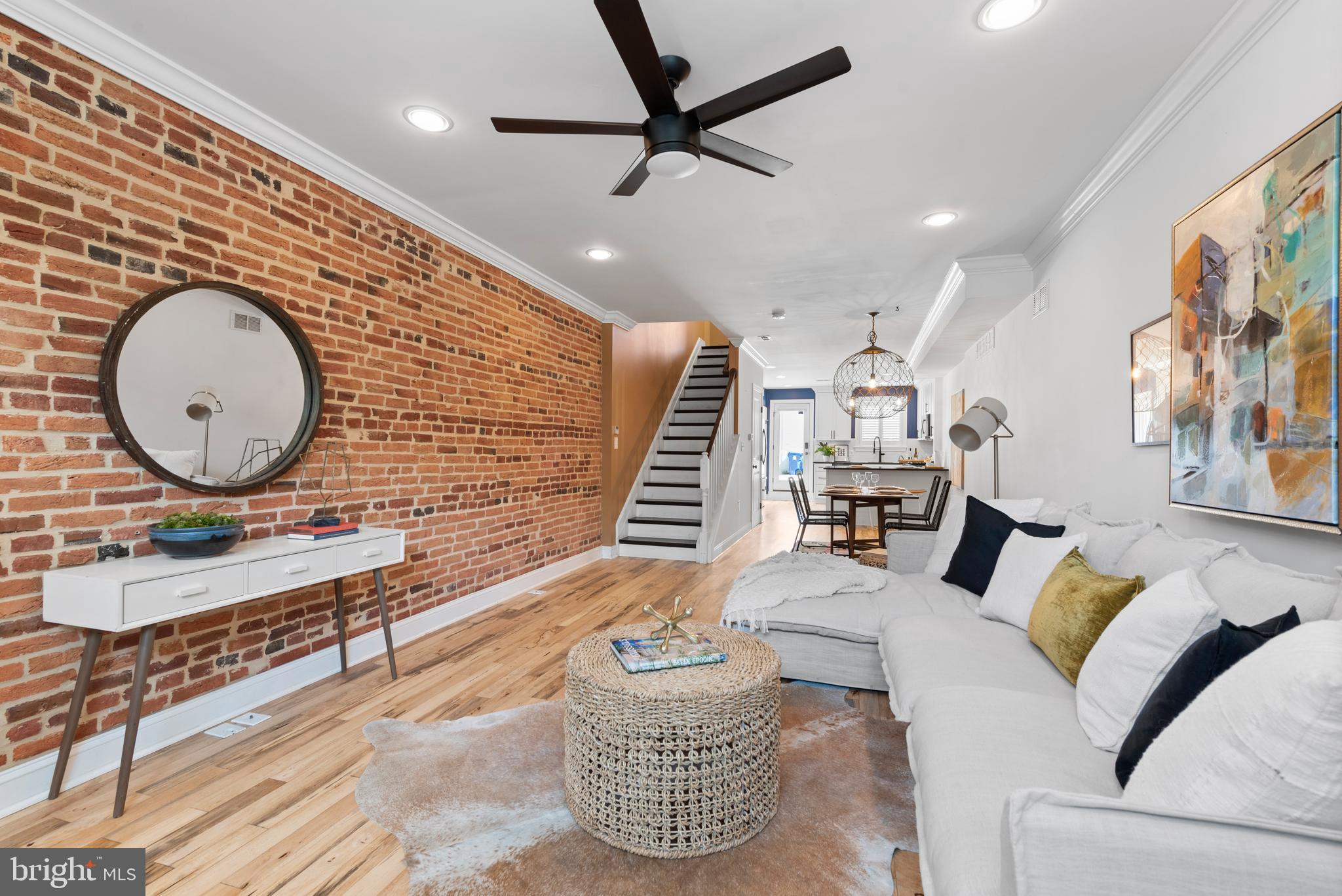 3032 Hudson Street Baltimore, MD 21224 - Photo 1 of 24 a living room with furniture a rug and a wall painting