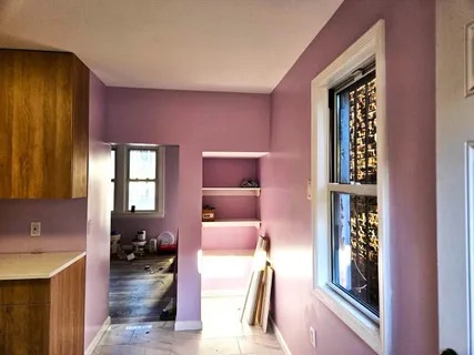 a hall way with furniture and a window