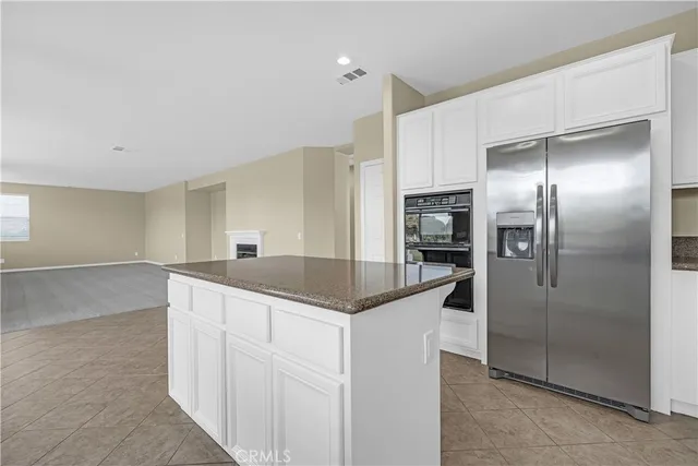 a kitchen with stainless steel appliances granite countertop a sink a stove cabinets and a counter top space