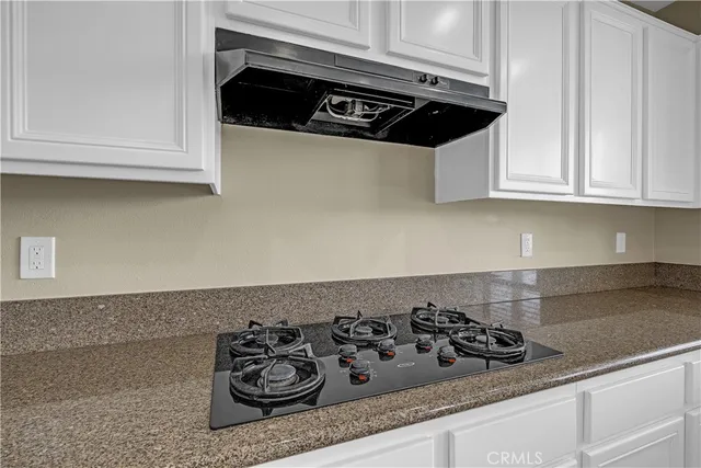 a kitchen with granite countertop a sink and a window