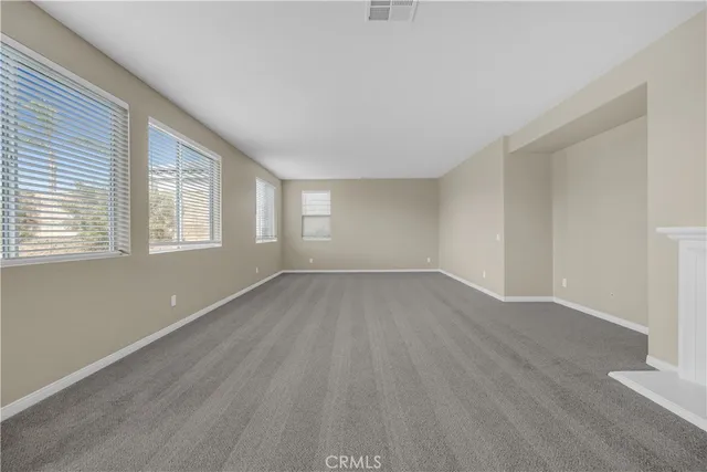 a view of an empty room and a fireplace