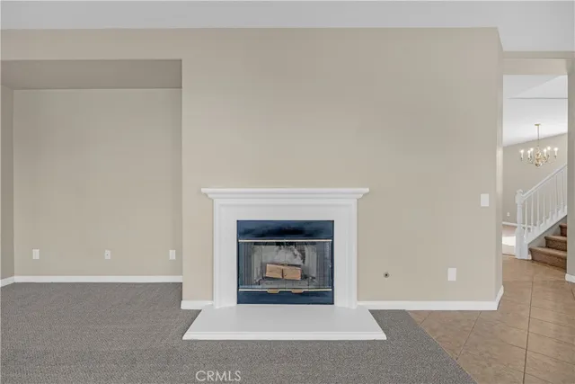 a view of empty room with kitchen and window