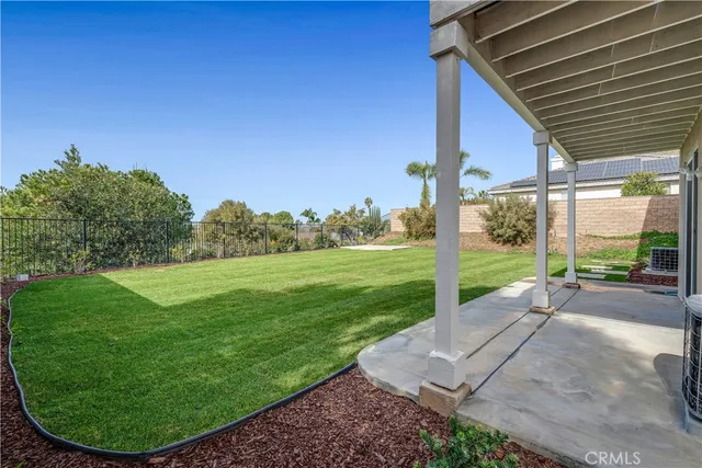 an aerial view of a house with a mountain