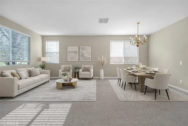 a living room with furniture a large window and a table