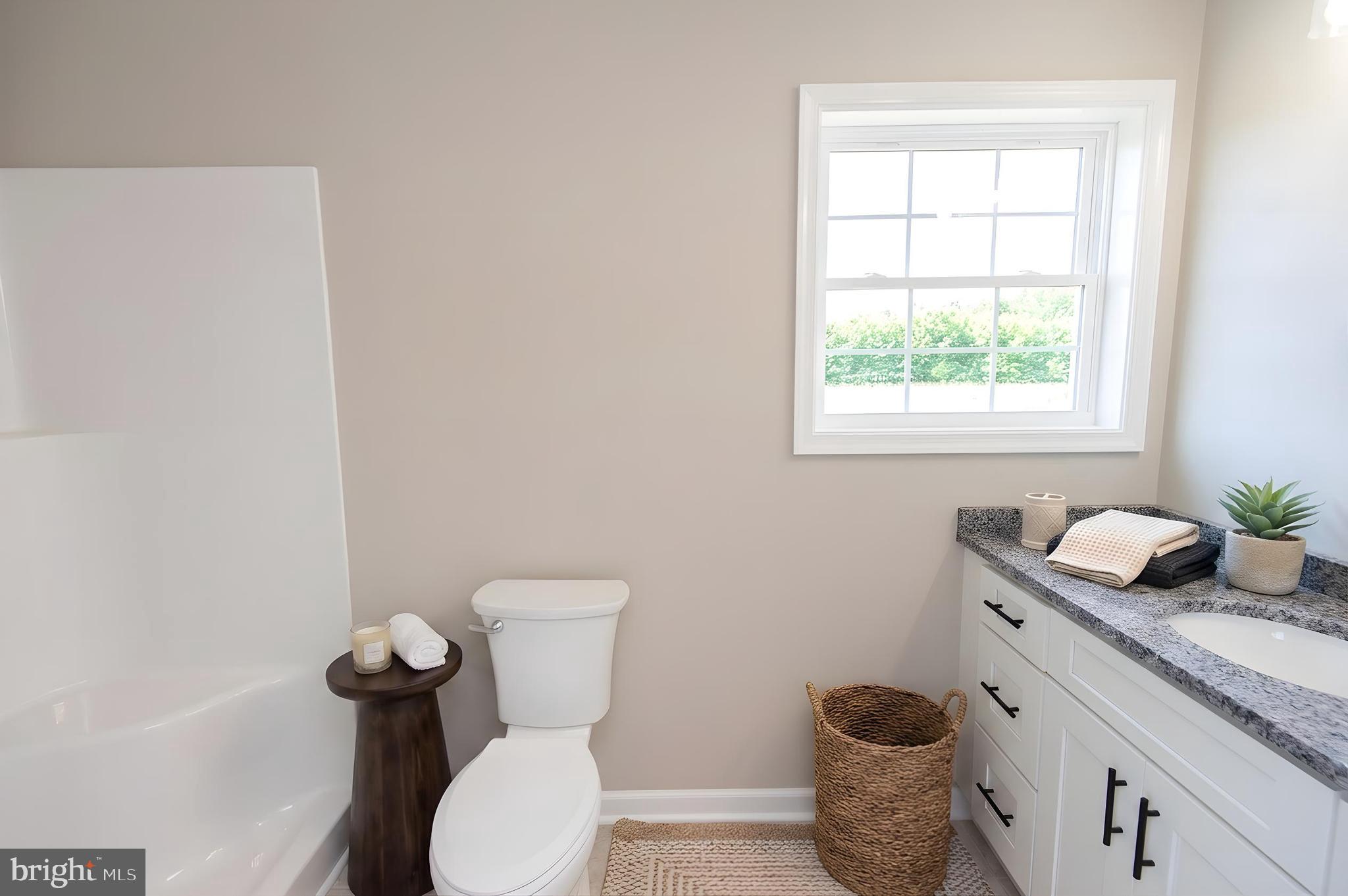 Wrights Rest Road Hurlock, MD 21643 - Photo 10 of 22 a bathroom with a granite countertop toilet and sink