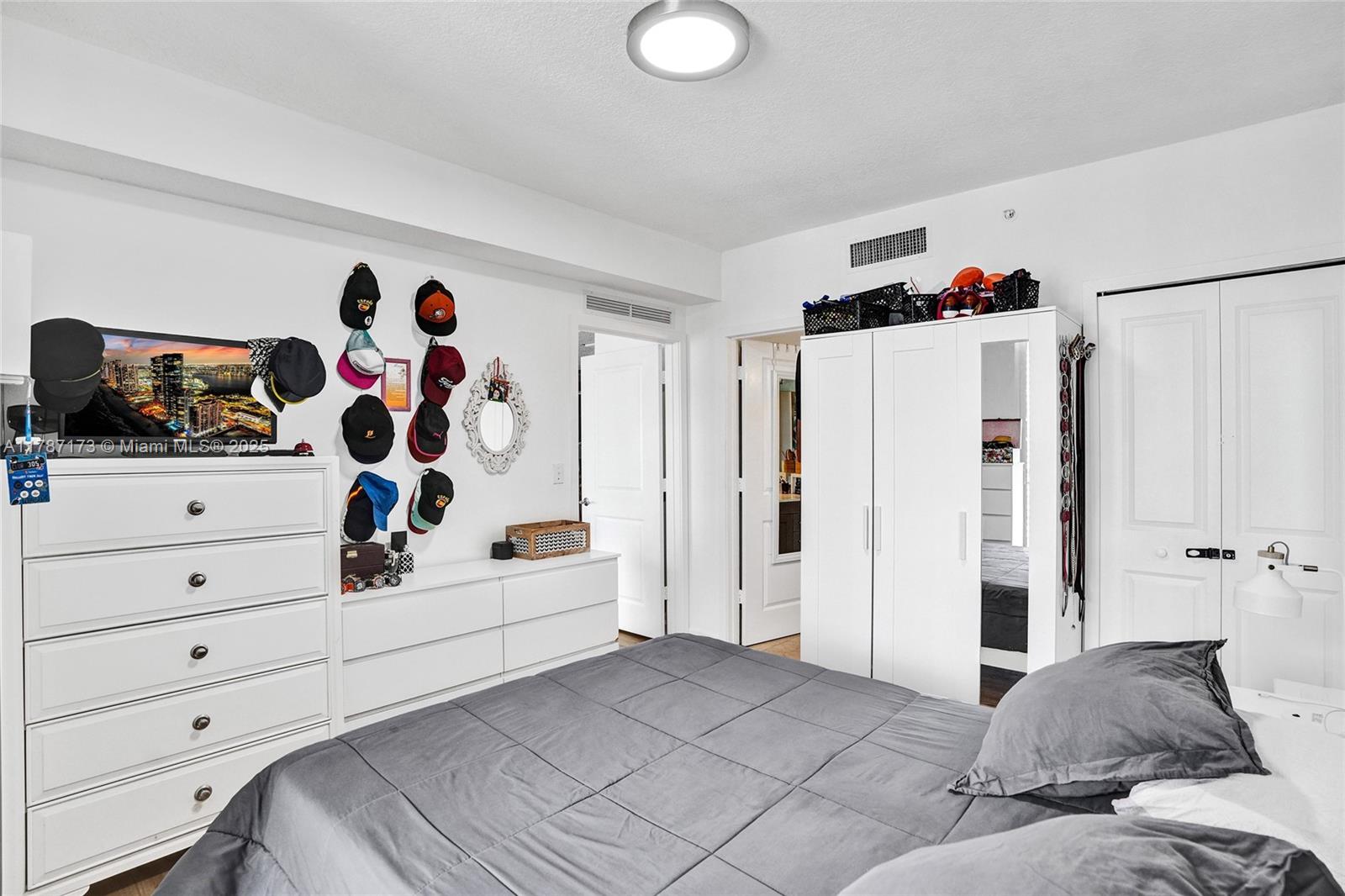 170 Southeast 14th Street, Unit 2907 Miami, FL 33131 - Photo 15 of 30 a bedroom with a bed and a white cabinet