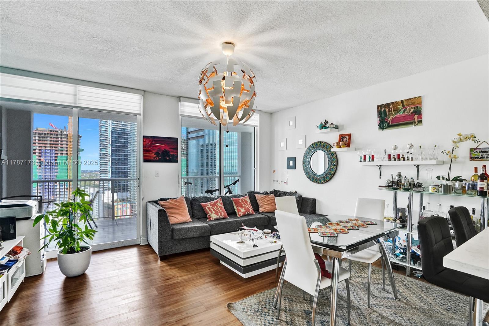 170 Southeast 14th Street, Unit 2907 Miami, FL 33131 - Photo 6 of 30 a living room with furniture a chandelier and a wooden floor