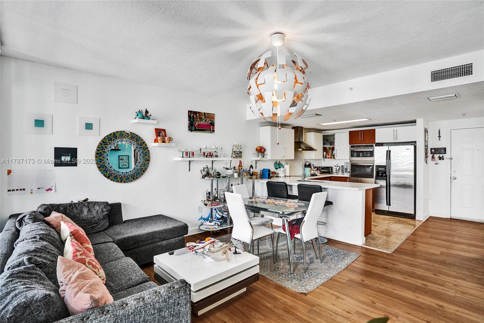 170 Southeast 14th Street, Unit 2907 Miami, FL 33131 - Photo 8 of 30 a living room with furniture kitchen view and a chandelier