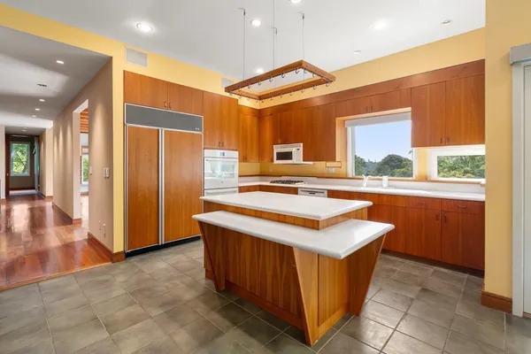 a kitchen with stainless steel appliances granite countertop a sink and a refrigerator