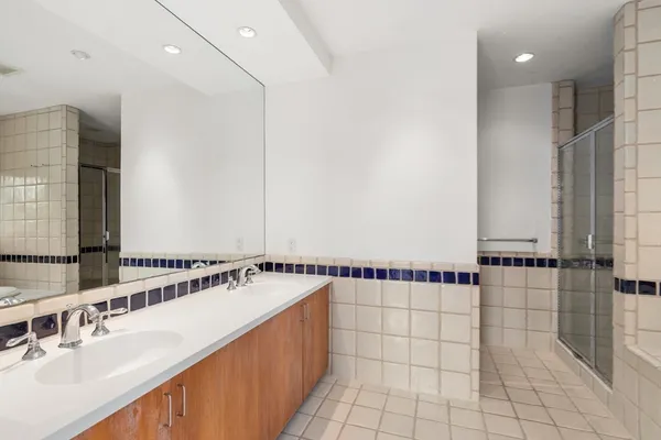 a bathroom with a sink a mirror and shower