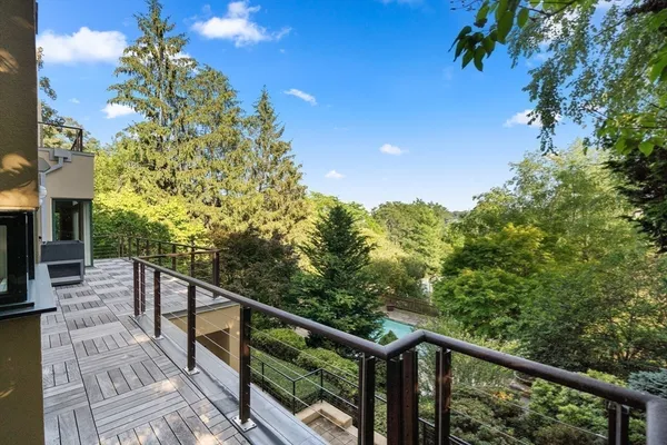 a view of a balcony with wooden floor and fence