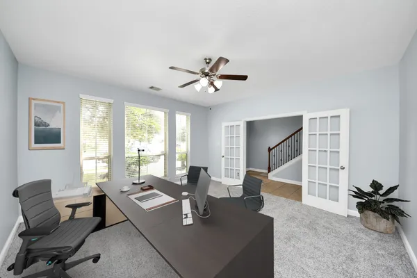 a living room with furniture a table and a large window