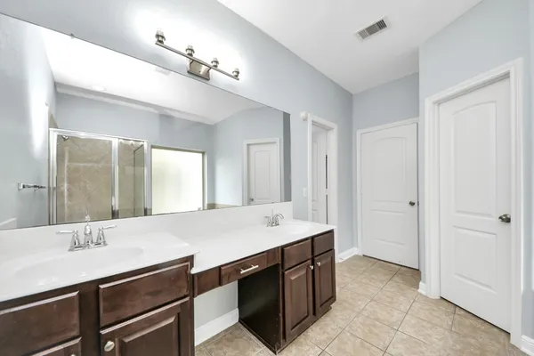 a bathroom with a sink vanity and mirror