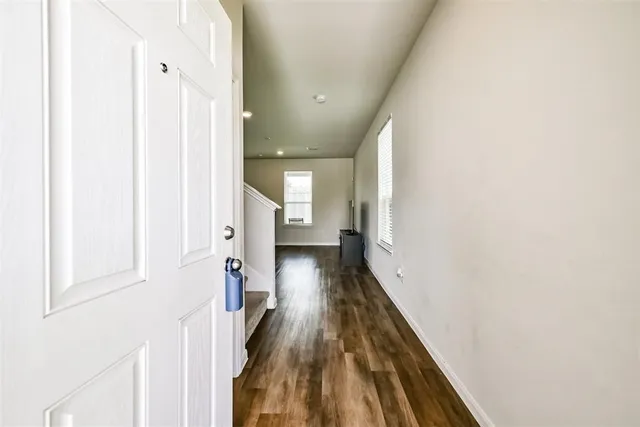 a view of hallway with wooden floor