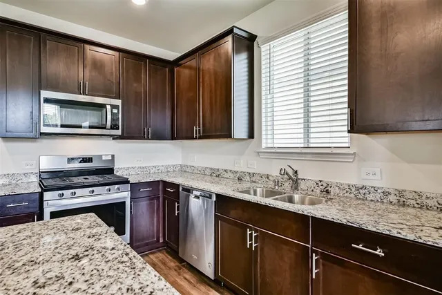 a kitchen with a sink stove and microwave