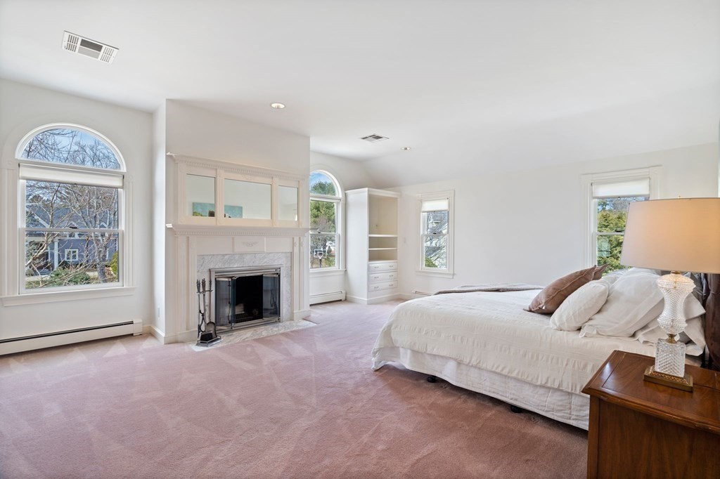 23 Louis Drive Wellesley, MA 02481 - Photo 22 of 42 a bedroom with a bed and a fireplace