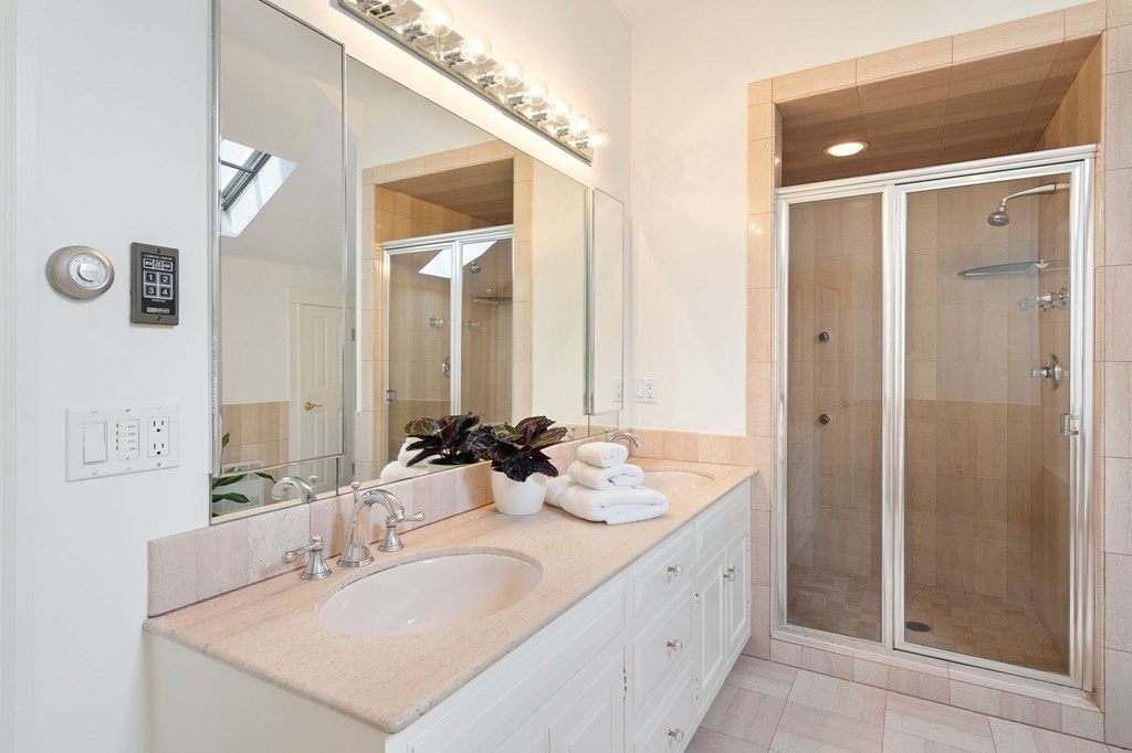 23 Louis Drive Wellesley, MA 02481 - Photo 24 of 42 a bathroom with double sink and a mirror