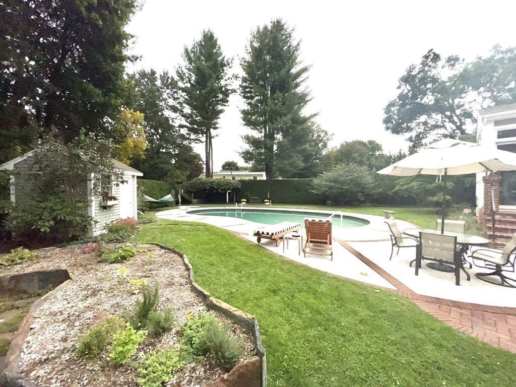23 Louis Drive Wellesley, MA 02481 - Photo 33 of 42 a view of a swimming pool with a patio and a yard