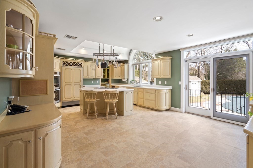 23 Louis Drive Wellesley, MA 02481 - Photo 6 of 42 a kitchen with stainless steel appliances a stove a sink and a refrigerator