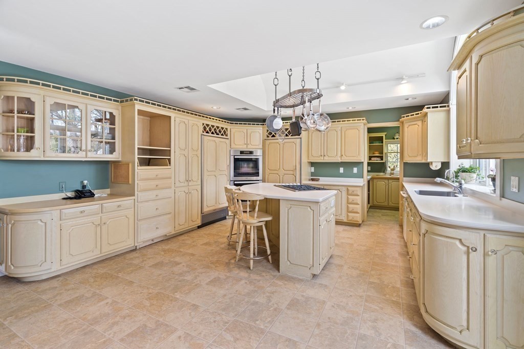 23 Louis Drive Wellesley, MA 02481 - Photo 8 of 42 a large white kitchen with lots of counter top space a sink appliances and cabinets