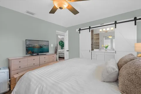a bedroom with a bed and a flat screen tv