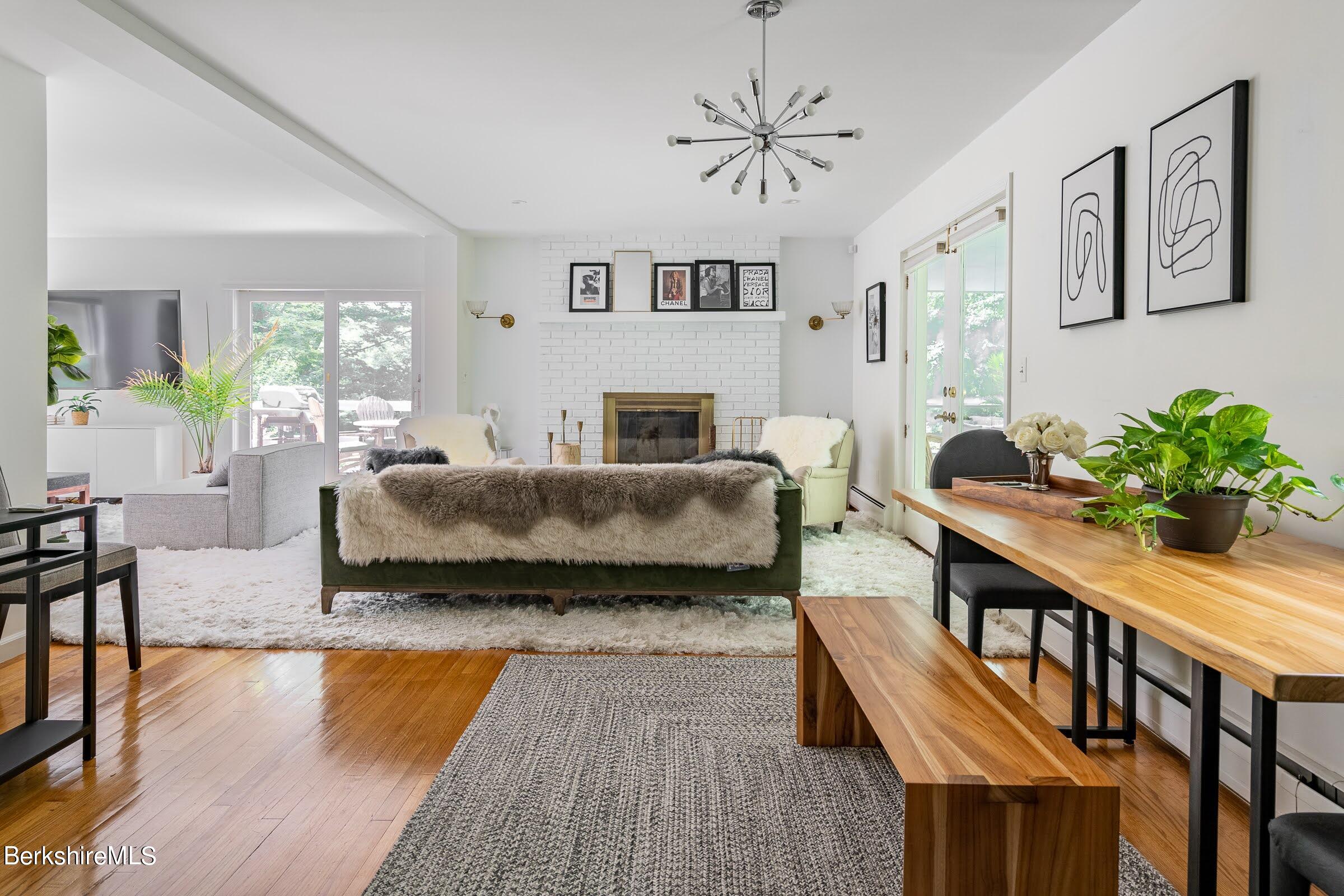 91 Brush Hill Road Great Barrington, MA 01230 - Photo 11 of 40 a bedroom with furniture wooden floor and a chandelier