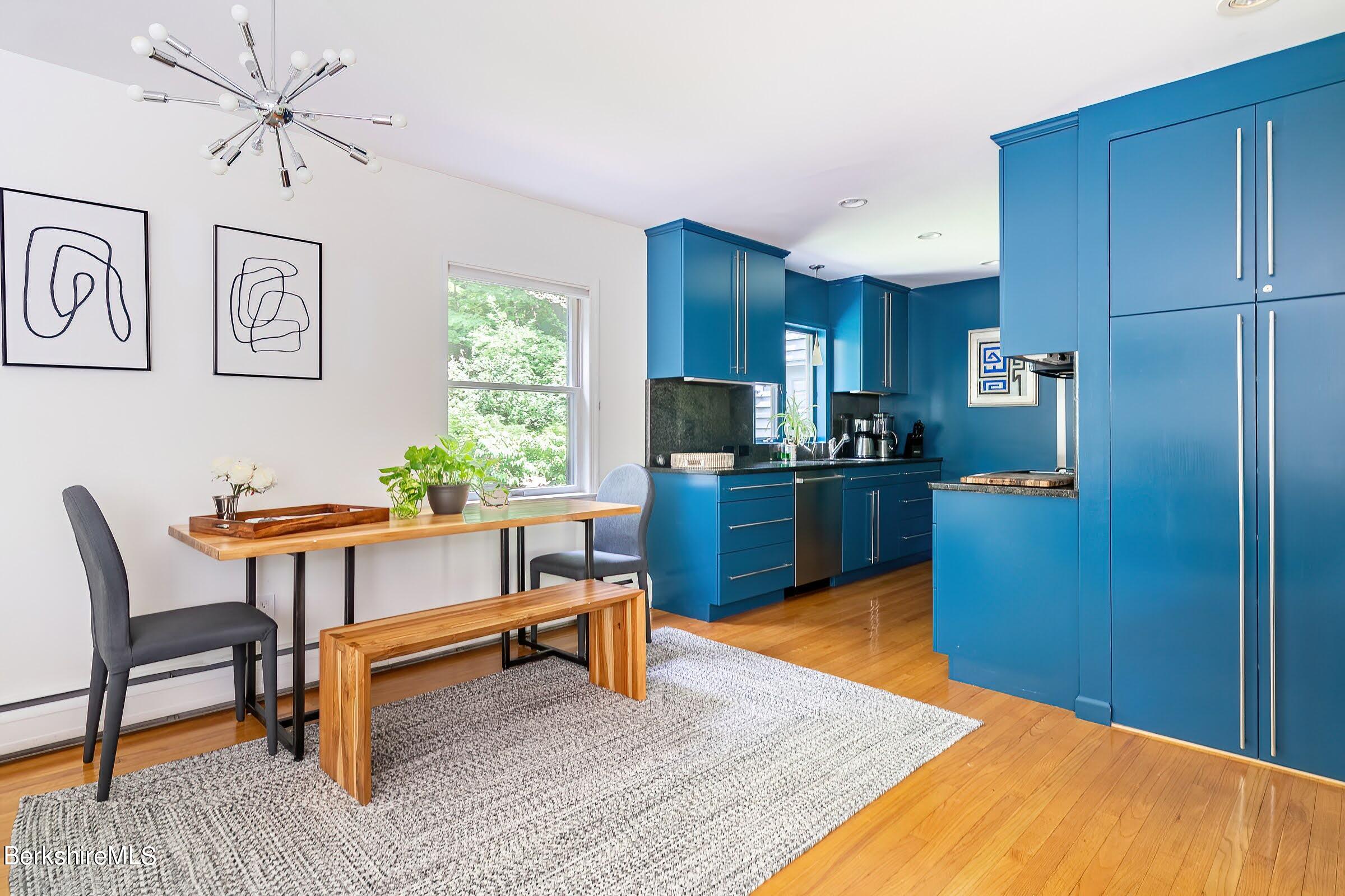 91 Brush Hill Road Great Barrington, MA 01230 - Photo 13 of 40 a kitchen with a table chairs refrigerator and cabinets